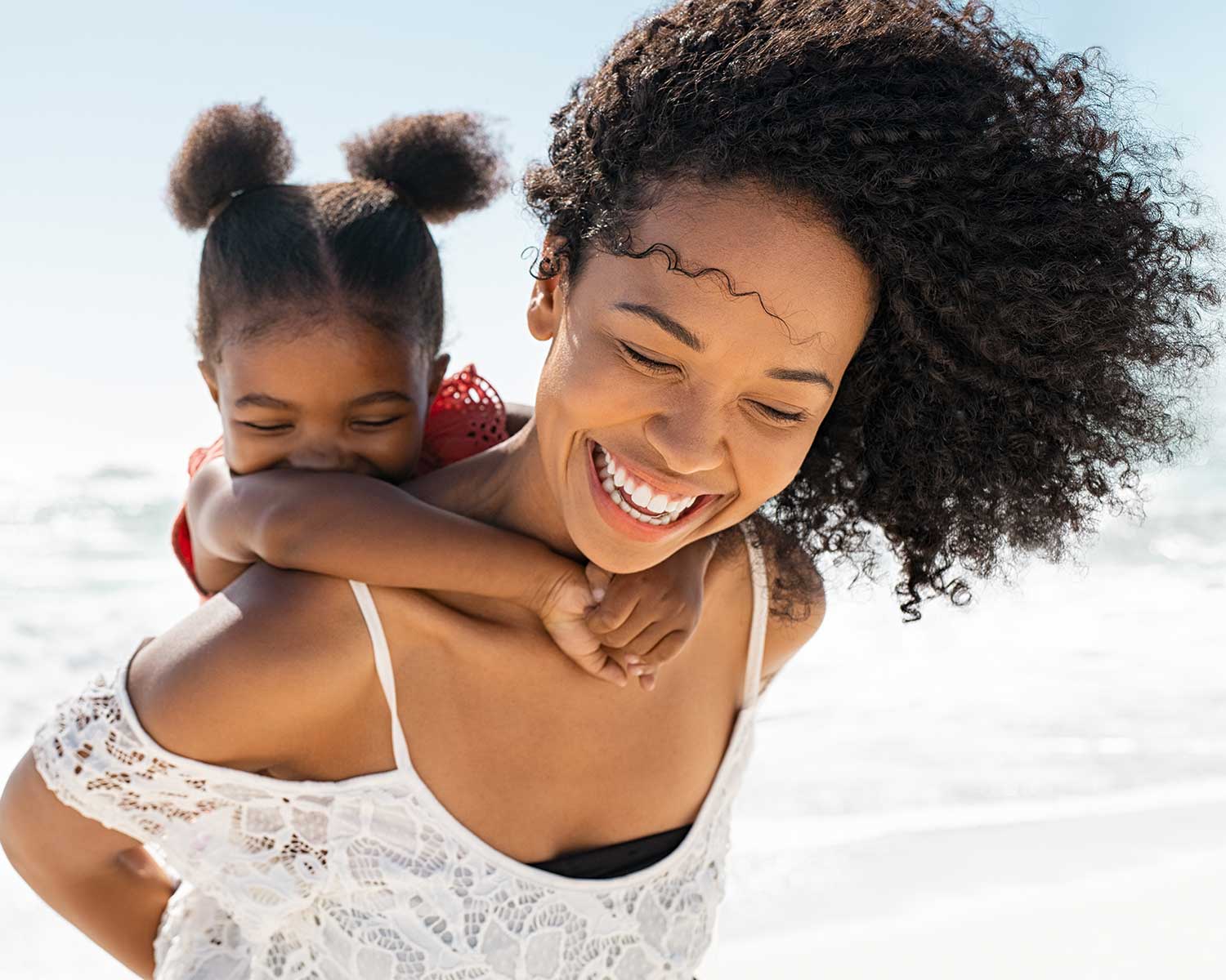 attrative woman with a baby on her back